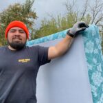 Bison Dump crew member carrying a mattress during a Salem junk removal job