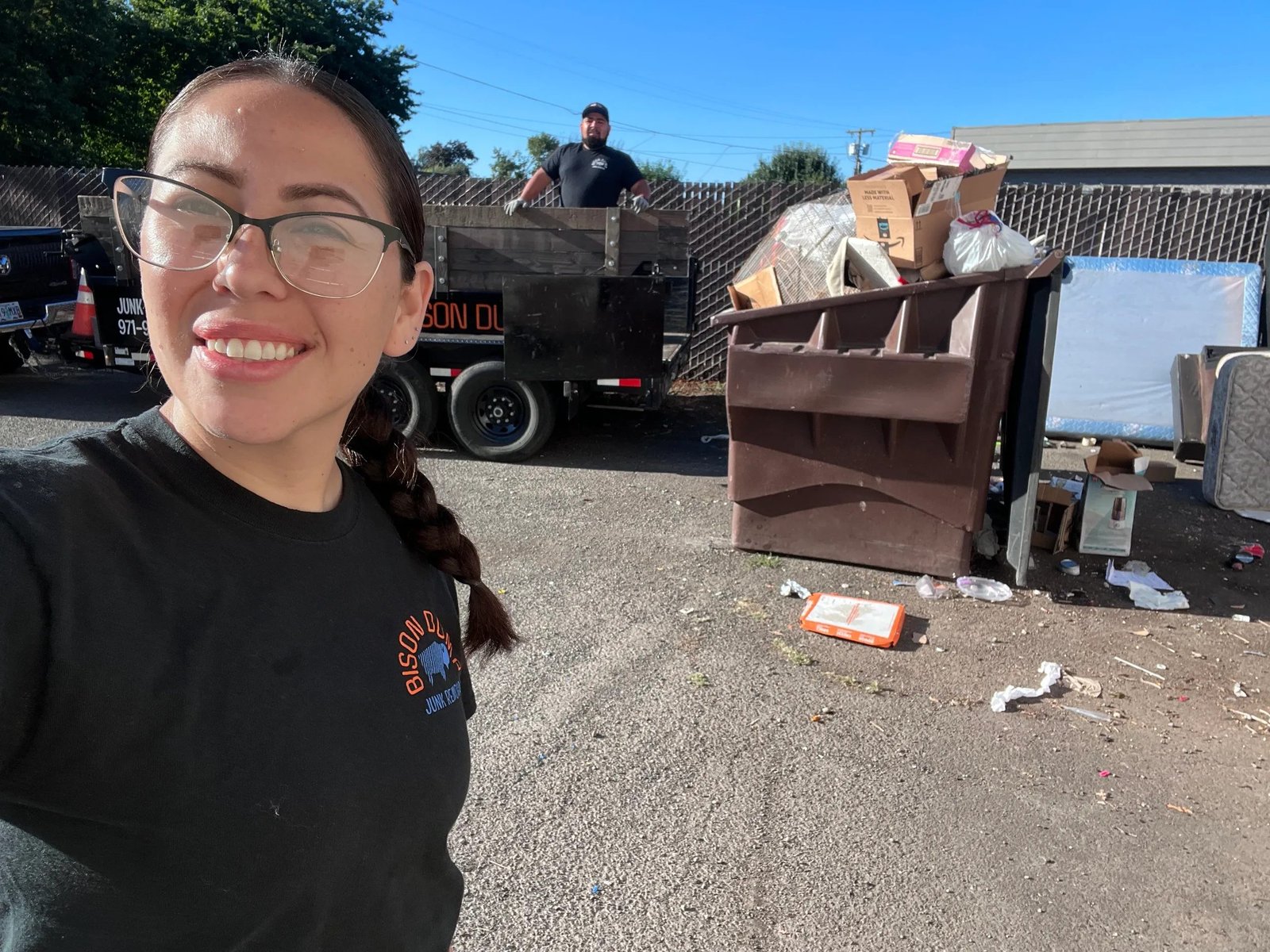 Bison Dump crew member with a fully loaded truck after a Salem commercial cleanout